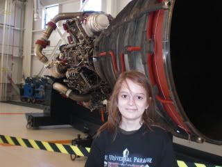 George in front of one of the Space Shuttle's engines.